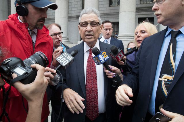 Former New York Assembly Speaker Sheldon Silver, center, is surrounded by reporters as he leaves federal court in New York after his sentencing in 2018.